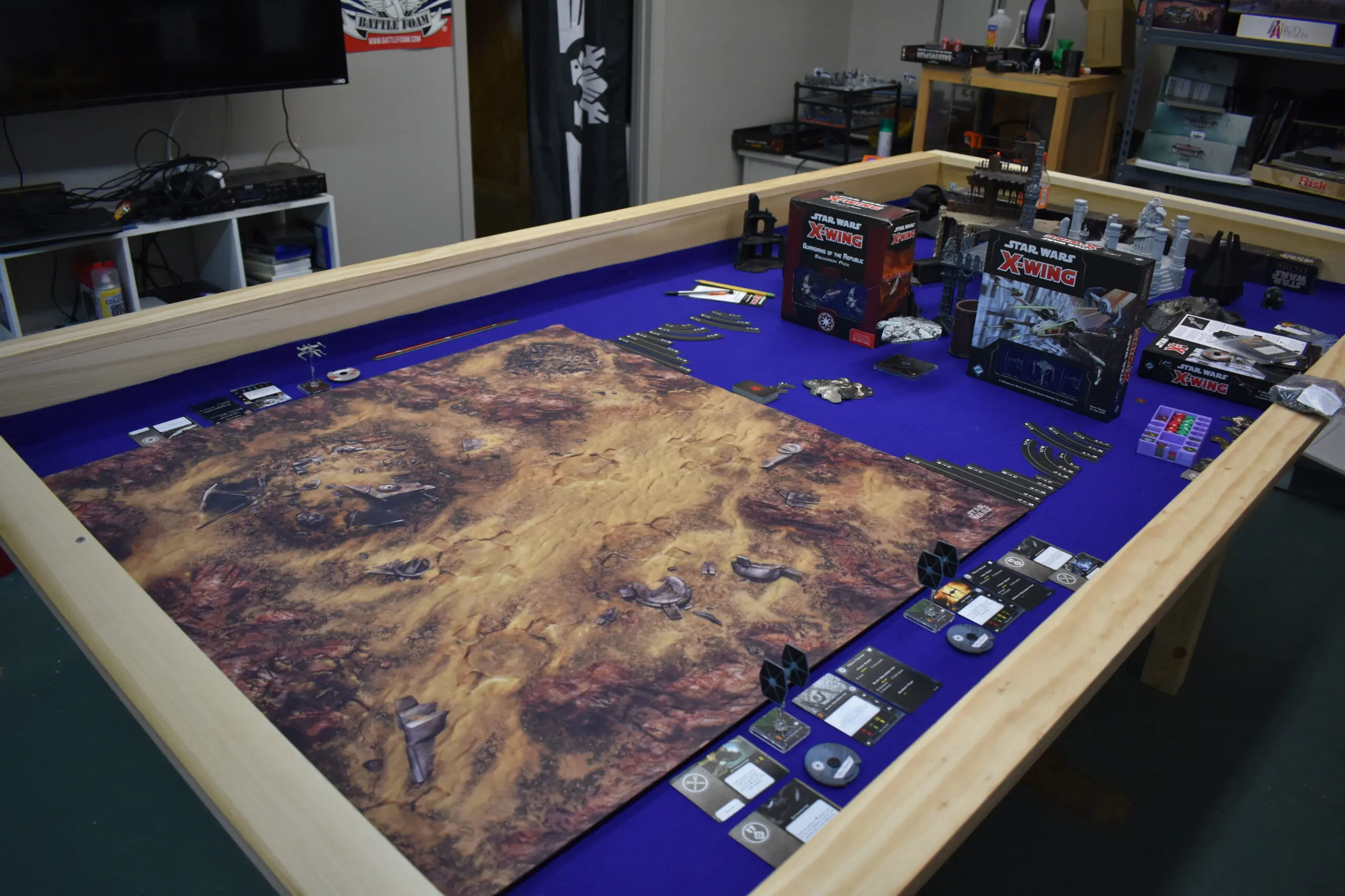 A tabletop wargaming table set up with Star Wars X-Wing miniatures and terrain at Blackwater Marsh Hobbies
